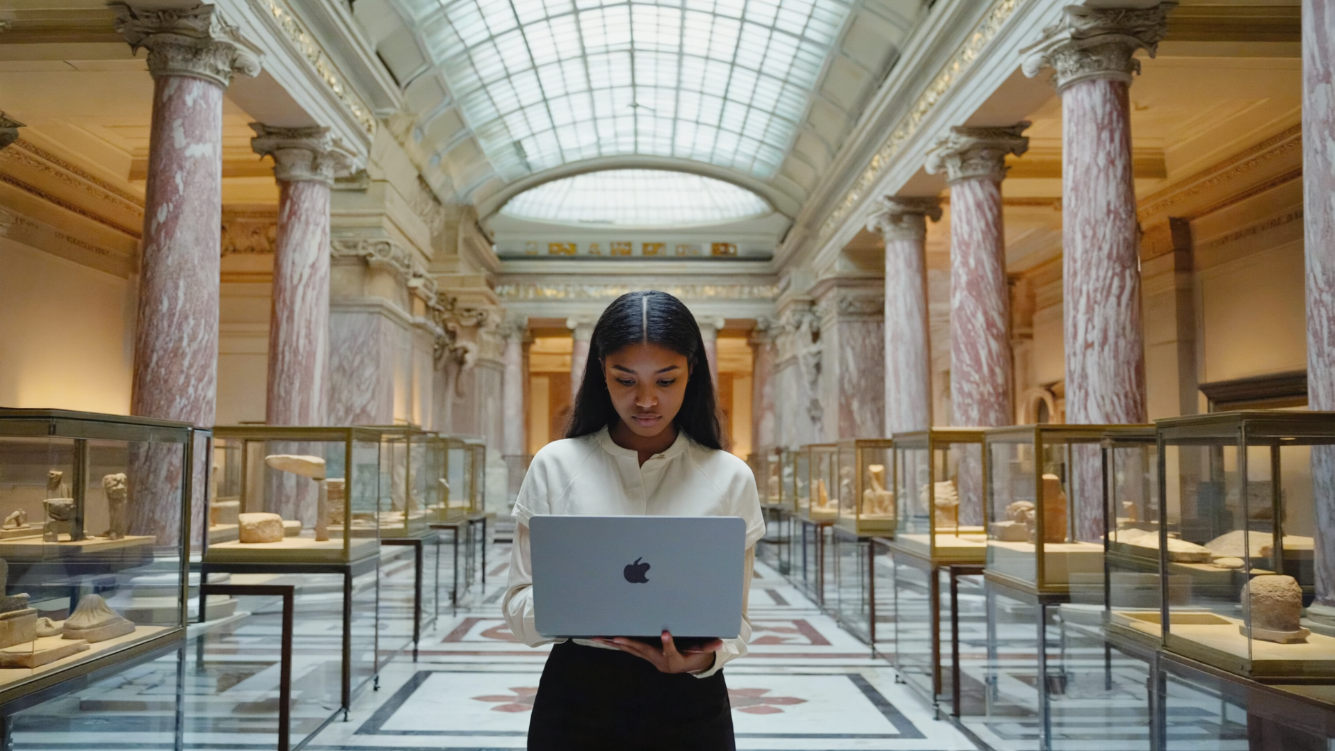 Gen4 a young lady behing a laptop creating content on his laptop he is in a museum backgr 23019915